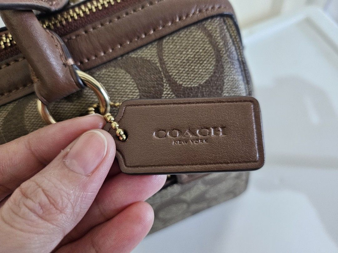Coach Rowan in Signature Canvass (Category: Luxury Bags & Wallets) located in Quezon City. Submitted by sheyguzman (Listing ID 1423333559, Image 3). Description: Rowan Satchel - Color Sig Brown - 10 1/2" (L) x 6 1/4" (H) x 5 1/2" (W) - Signature coated canvas fabric lining - Exterior Front Zip Pocket - Top Zip Closure - Detachable, Adjustable Long Strap for Shoulder or Crossbody Wear - 1 Inside Zip Pocket and multifunction pockets.