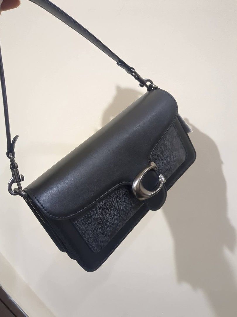Coach Tabby Shoulder Bag 26cm (Category: Luxury Bags & Wallets) located in Las Pinas. Submitted by luxlahvu2017 (Listing ID 1423329455, Image 3). Description: - Coach Tabby shoulder bag - Color : Black - Signature C clasp - Detachable shoulder strap - Main compartment with zipper closure - Interior pocket - Coach leather tag inside.