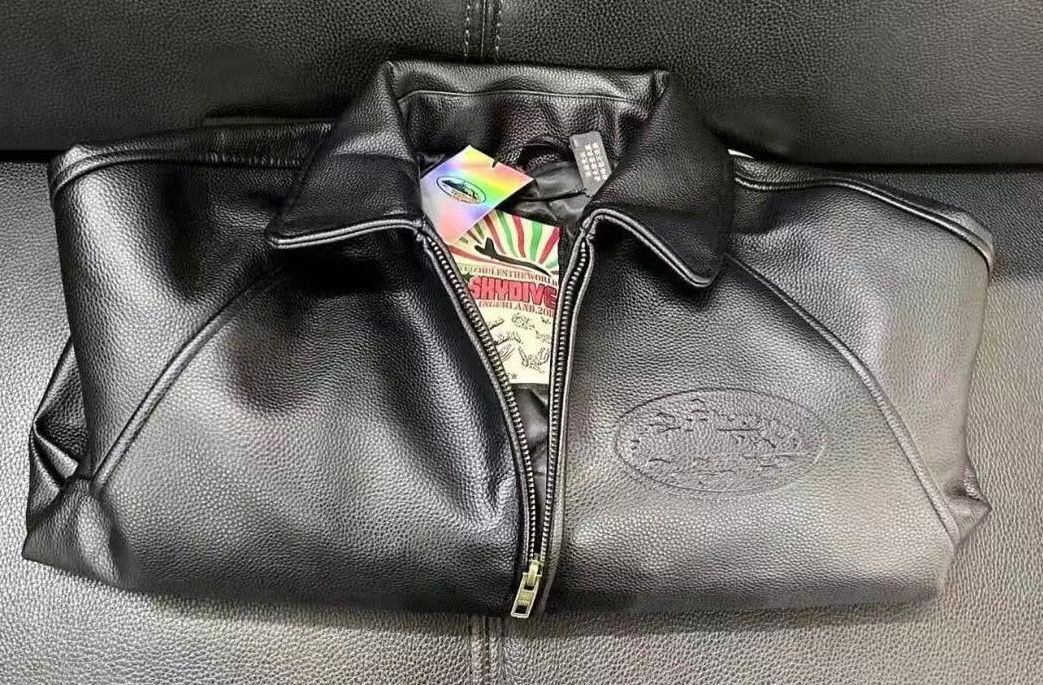 CORTEIZ LEATHER JACKET (zip up) (Category: Coats, Jackets and Outerwear) located in Caloocan City. Submitted by dontii (Listing ID 1423421559, Image 3). Description: Black leather varsity jacket with white striped cuffs and hem. Features a front zipper closure and a collar. The back of the jacket has an embossed corteiz logo. The jacket also has a corteiz logo on the chest..