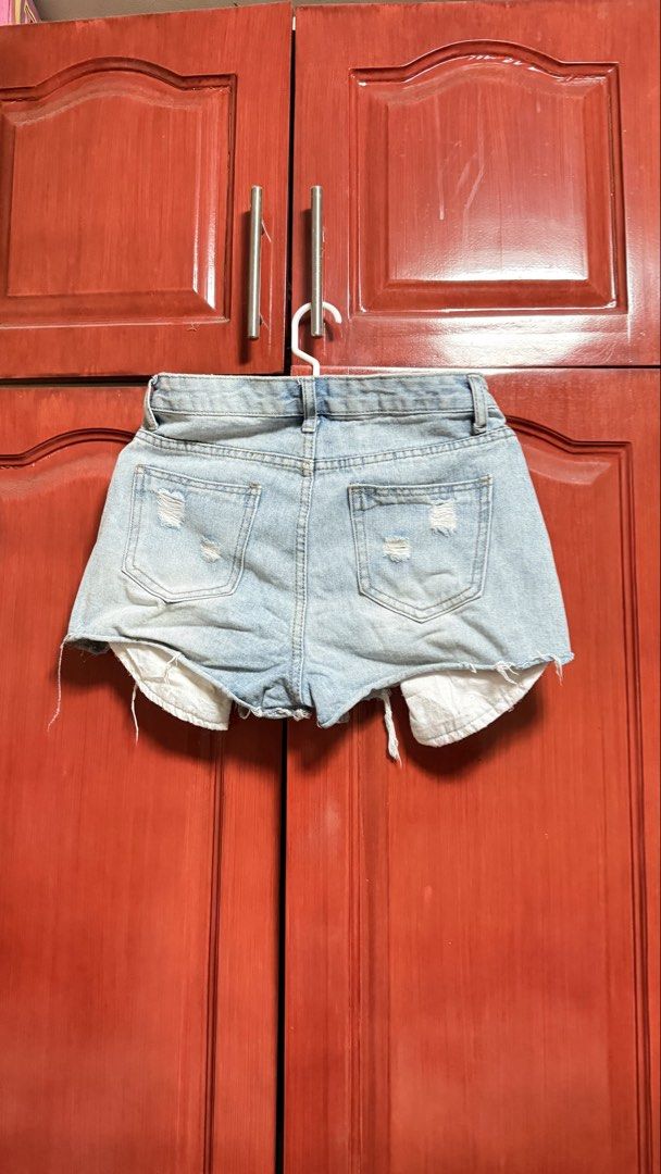Distressed Denim Shorts with Sequin Detail (Category: Shorts) located in Amadeo. Submitted by beaflr (Listing ID 1423406801, Image 2). Description: - Light wash denim shorts - Distressed detailing - Button and zipper closure - Pink sequin accents on front - Size 26-27.