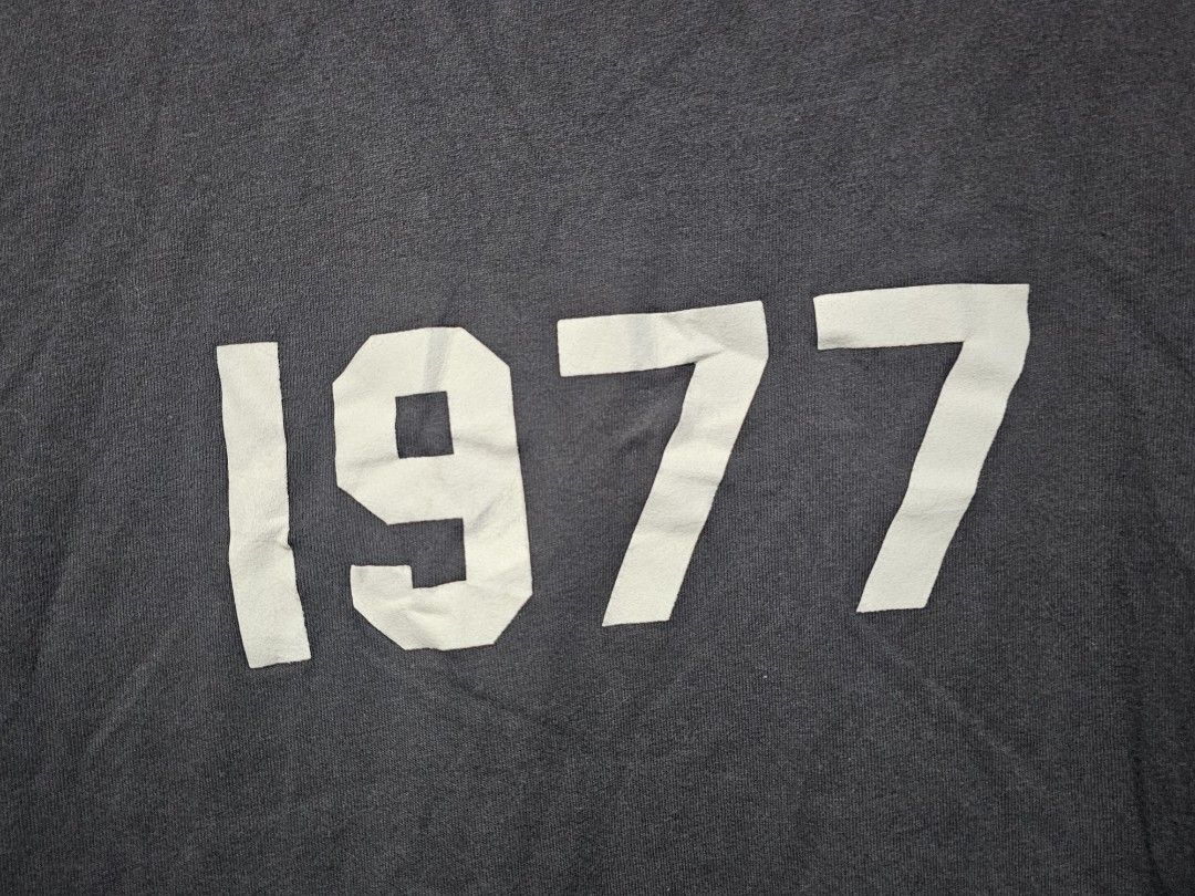 Essentials 1977 Long Sleeve Shirt (Category: Tshirts & Polo Shirts ) located in San Jose del Monte. Submitted by levanthrift (Listing ID 1423404284, Image 2). Description: 23x28 Essentials long sleeve shirt in black. Features the number "1977" printed on the front. The shirt has a small Essentials logo patch on the back of the neck. Made of 100% cotton. Size S. Made in China..