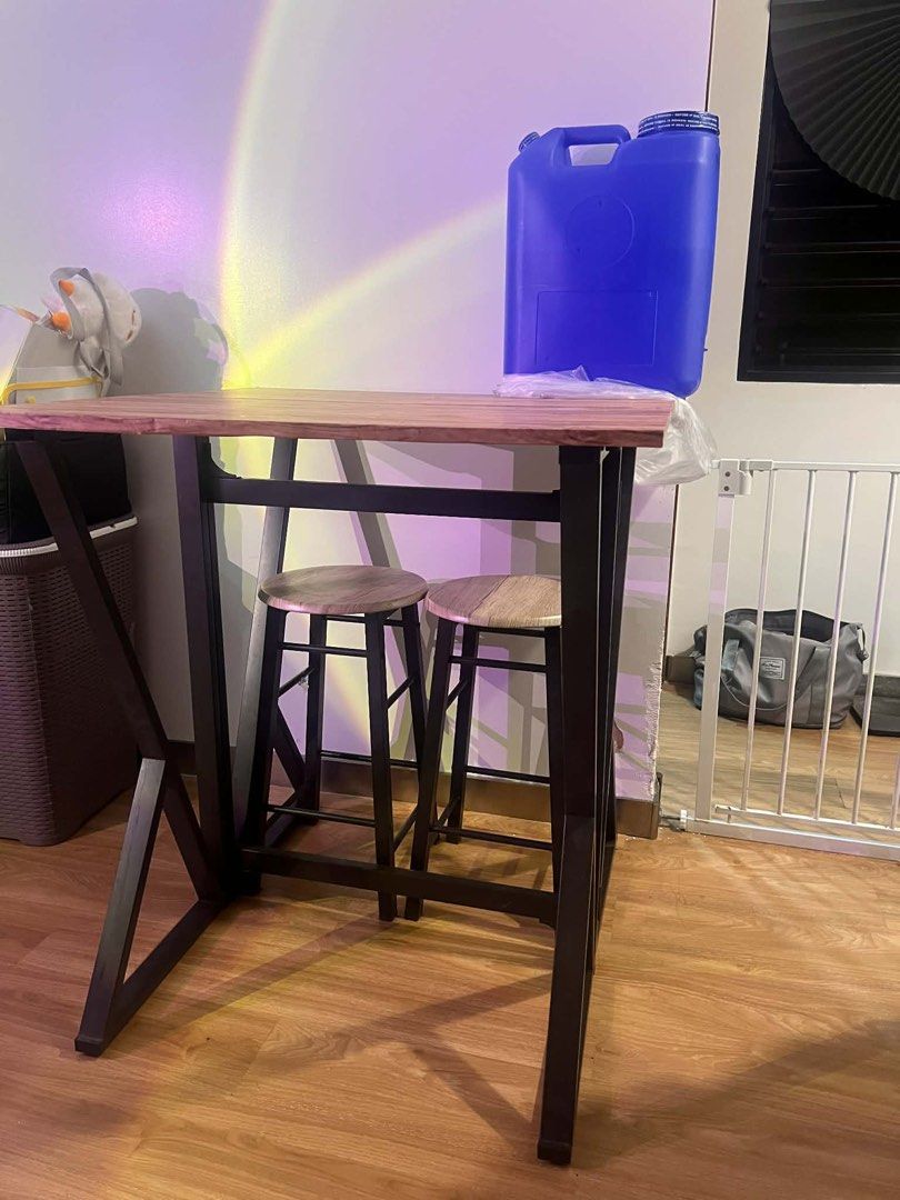 Foldable Table with Stools (Category: Tables & Sets) located in Quezon City. Submitted by sell4less123 (Listing ID 1423372655, Image 2). Description: - Foldable table for space-saving storage. - Wooden tabletop with a dark metal frame. - Includes two matching stools. - Ideal for small apartments or breakfast nooks. - Table folds away when not in use. 80x80in.