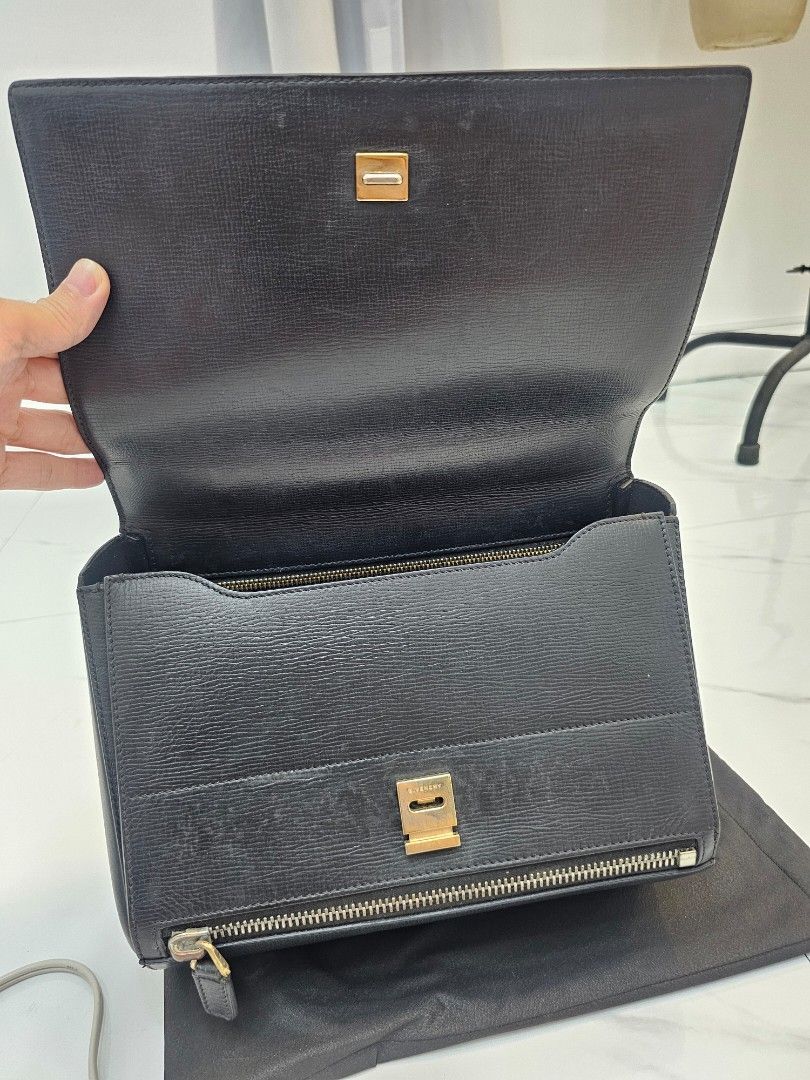 Givenchy Black Clutch Bag (Category: Luxury Bags & Wallets) located in Las Pinas. Submitted by vanpru (Listing ID 1423323408, Image 3). Description: Givenchy pandora box 2 way bag Good condition Minimal signs of use - Authentic Givenchy clutch bag - Classic black color - Elegant gold-tone hardware - Secure zip closure - Stylish flap with clasp - Interior with multiple compartments - Convenient strap.