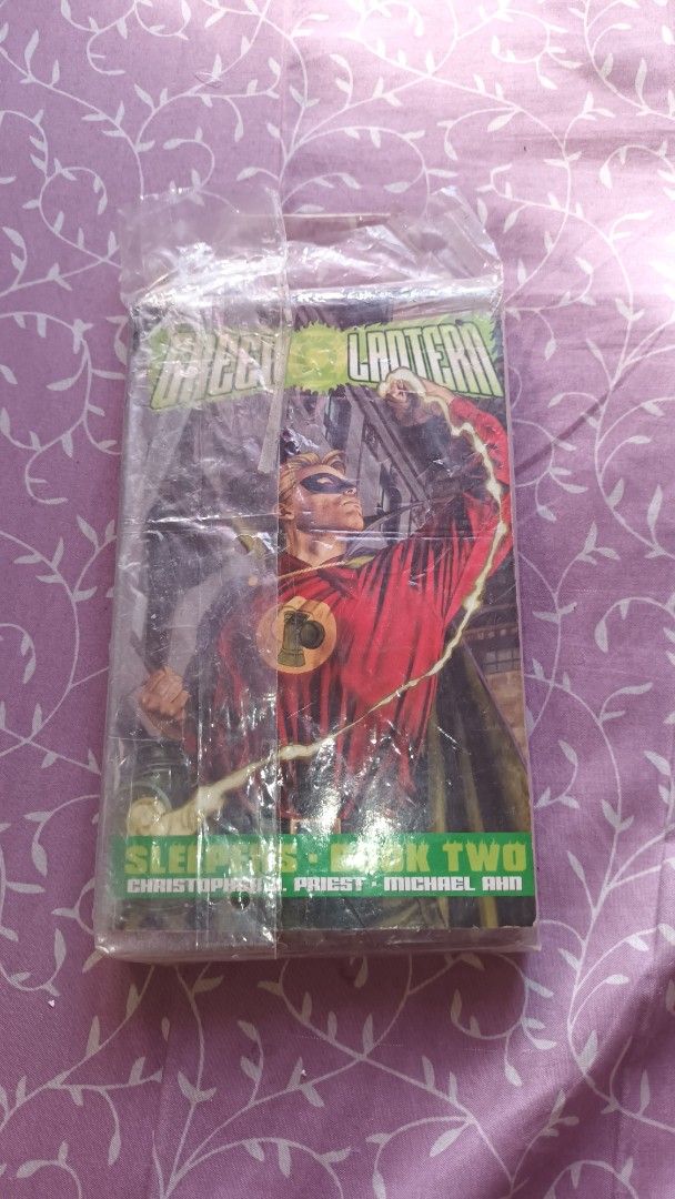 Green Lantern: Sleepers Book Two (Category: Comics & Manga) located in Quezon City. Submitted by gerald19.9. (Listing ID 1423332632, Image 2). Description: - Green Lantern: Sleepers Book Two book - Sealed in plastic for protection - Featuring Christopher J. Priest and Michael Bair - Classic Green Lantern cover art in red and green - Includes story description and DC Comics logo on the back.