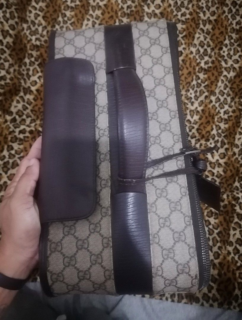 Gucci GG Supreme Rolling Suitcase (Category: Luxury Bags & Wallets) located in Cebu City. Submitted by roadthrift (Listing ID 1423434262, Image 3). Description: - Authentic Gucci rolling suitcase - Iconic GG Supreme canvas - Brown leather accents - Top handle and retractable handle - Smooth-rolling wheels - Front zipper pocket - Gucci logo lock - Gucci label inside - Dimensions: Approximately 25cm x 16cm x 40cm.