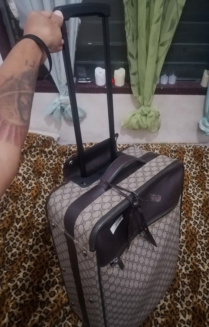 Gucci GG Supreme Rolling Suitcase (Category: Luxury Bags & Wallets) located in Cebu City. Submitted by roadthrift (Listing ID 1423434262, Image 2). Description: - Authentic Gucci rolling suitcase - Iconic GG Supreme canvas - Brown leather accents - Top handle and retractable handle - Smooth-rolling wheels - Front zipper pocket - Gucci logo lock - Gucci label inside - Dimensions: Approximately 25cm x 16cm x 40cm.