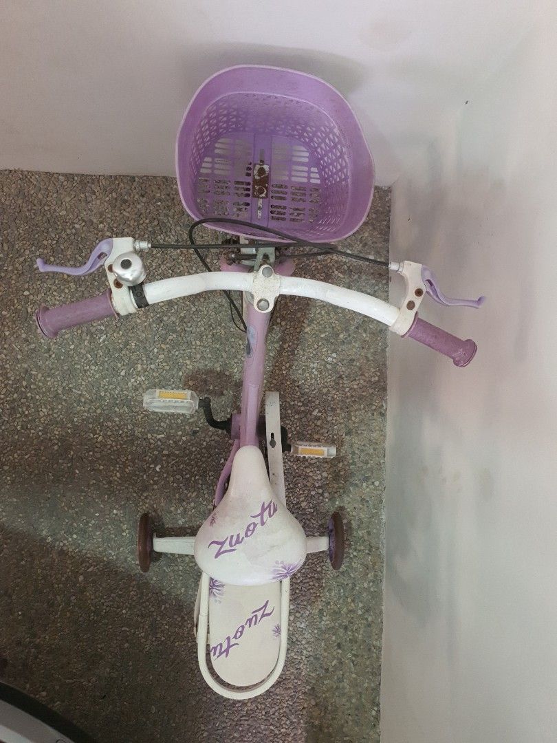 Kids' Bicycle with Basket and Training Wheels (Category: Bicycles) located in Pasig City. Submitted by blissfultin (Listing ID 1423333557, Image 2). Description: - Purple frame and basket - Includes training wheels - Comfortable white seat with design - Purple handlebar accents - Features a bell - Includes a rear seat - Designed for young children 09778317238.