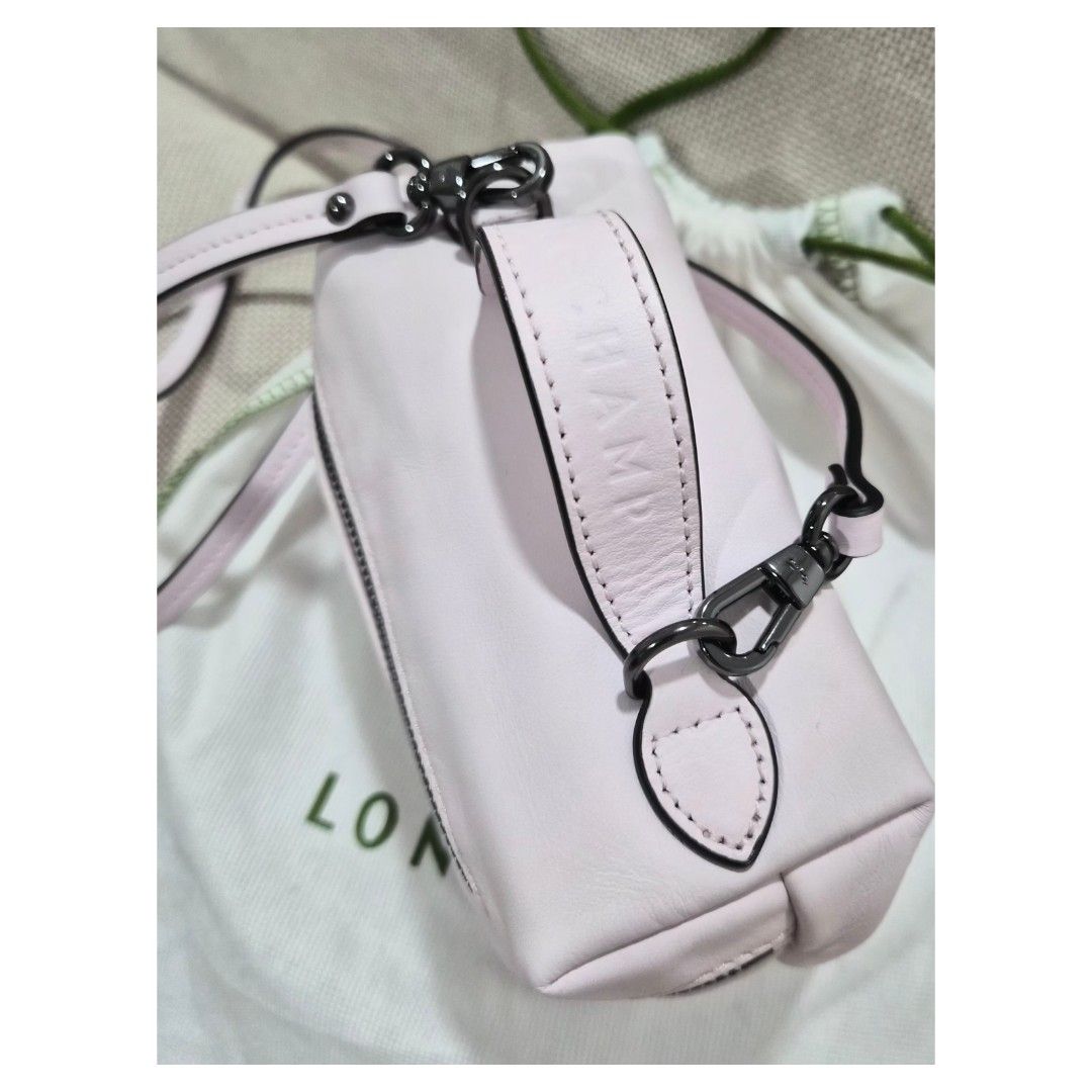Longchamp Xtra Vanity XS (Category: Luxury Bags & Wallets) located in Bacoor. Submitted by _sysells (Listing ID 1423350458, Image 3). Description: Le Pliage Xtra XS Vanity Pink - Leather. Purchased from Rustan's last year. Has a minor scratch as shown in the 4th photo. Inclusions: dust bag and care card. Zip closure Detachable shoulder strap 1 inside flat pocket RFS: Downsizing my bag collection..