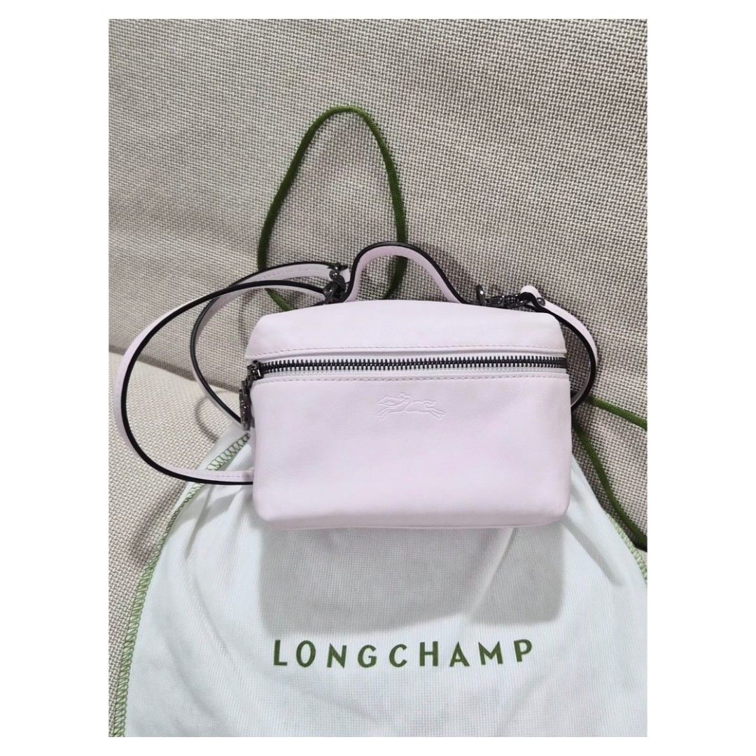 Longchamp Xtra Vanity XS (Category: Luxury Bags & Wallets) located in Bacoor. Submitted by _sysells (Listing ID 1423350458, Image 2). Description: Le Pliage Xtra XS Vanity Pink - Leather. Purchased from Rustan's last year. Has a minor scratch as shown in the 4th photo. Inclusions: dust bag and care card. Zip closure Detachable shoulder strap 1 inside flat pocket RFS: Downsizing my bag collection..