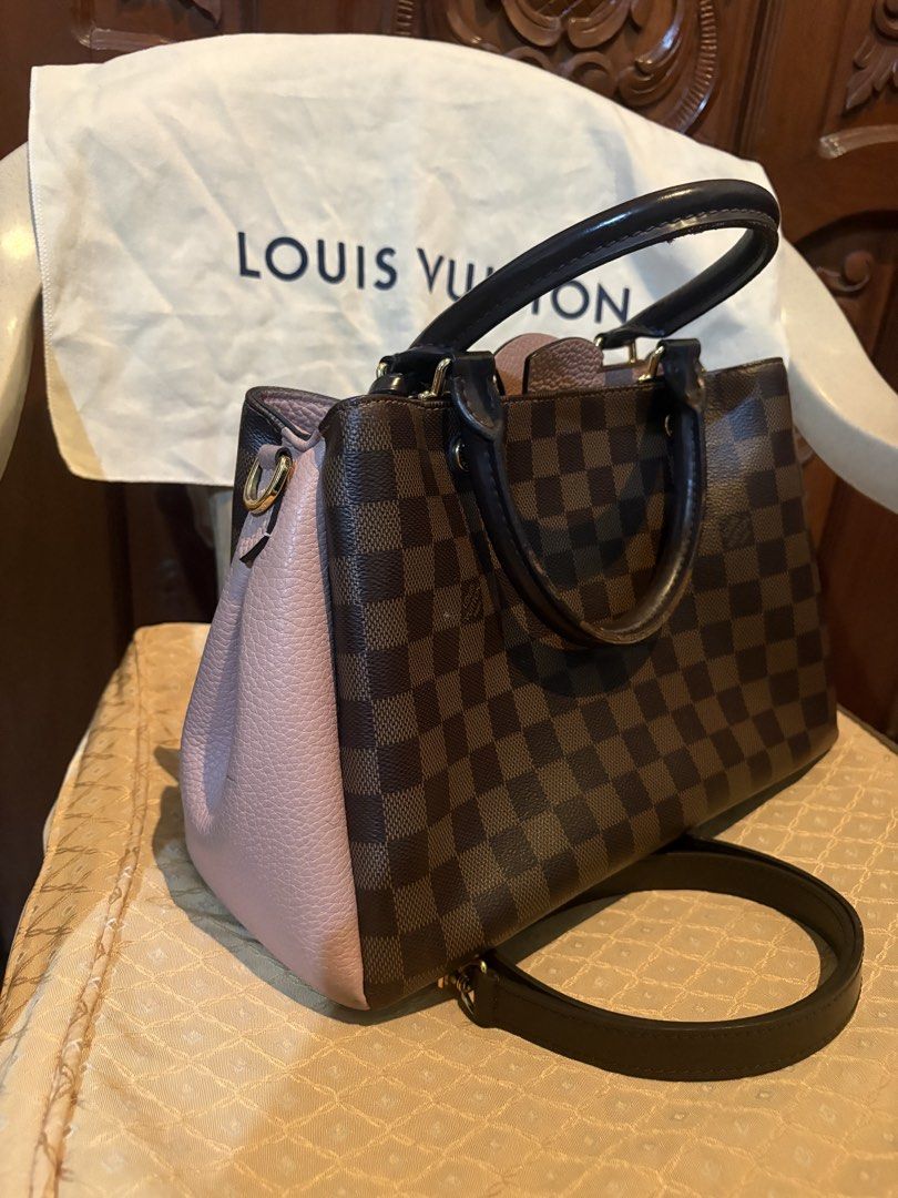 Louis Vuitton Damier Brittany Handbag (Category: Luxury Bags & Wallets) located in Marikina City. Submitted by ellemss (Listing ID 1423401806, Image 2). Description: Authentic Louis Vuitton handbag in Damier Ebene canvas. Features a brown and pink color scheme with a top handle and a detachable shoulder strap. Includes a dust bag. The interior has a zippered pocket. Gold-tone hardware is visible on the bag. The bag has protective feet on the bott