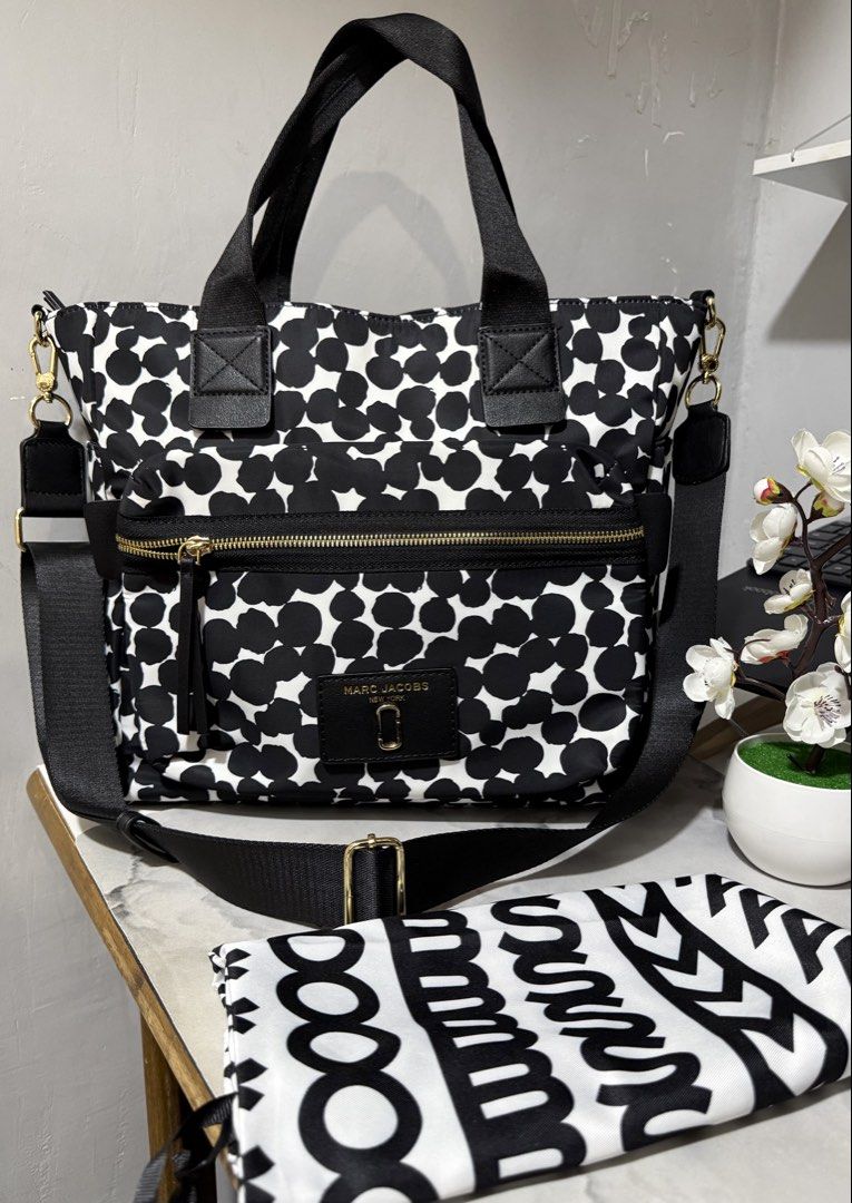 Marc Jacobs Nylon 2-Way Bag (Category: Luxury Bags & Wallets) located in Antipolo. Submitted by lelaimanz (Listing ID 1423278653, Image 1). Description: - Original Marc Jacobs Nylon Handbag and Crossbody bag - Size: height 12 inches | width 16.5 inches - Black and white polka dot pattern - Zip closure - Multiple compartments - Detachable / Adjustable Crossbody strap - Includes dust bag - Gold-tone hardwares - Made in Vietnam - NO flaws - like new