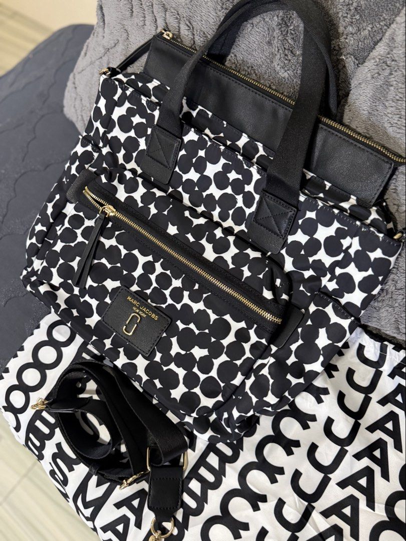 Marc Jacobs Nylon 2-Way Bag (Category: Luxury Bags & Wallets) located in Antipolo. Submitted by lelaimanz (Listing ID 1423278653, Image 2). Description: - Original Marc Jacobs Nylon Handbag and Crossbody bag - Size: height 12 inches | width 16.5 inches - Black and white polka dot pattern - Zip closure - Multiple compartments - Detachable / Adjustable Crossbody strap - Includes dust bag - Gold-tone hardwares - Made in Vietnam - NO flaws - like new