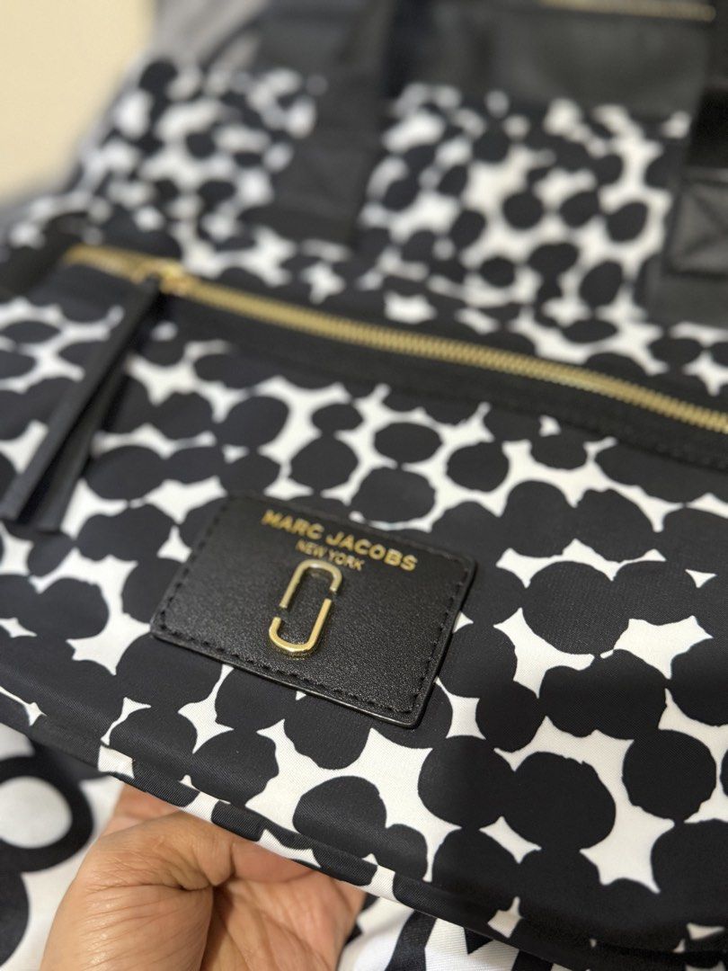 Marc Jacobs Nylon 2-Way Bag (Category: Luxury Bags & Wallets) located in Antipolo. Submitted by lelaimanz (Listing ID 1423278653, Image 3). Description: - Original Marc Jacobs Nylon Handbag and Crossbody bag - Size: height 12 inches | width 16.5 inches - Black and white polka dot pattern - Zip closure - Multiple compartments - Detachable / Adjustable Crossbody strap - Includes dust bag - Gold-tone hardwares - Made in Vietnam - NO flaws - like new