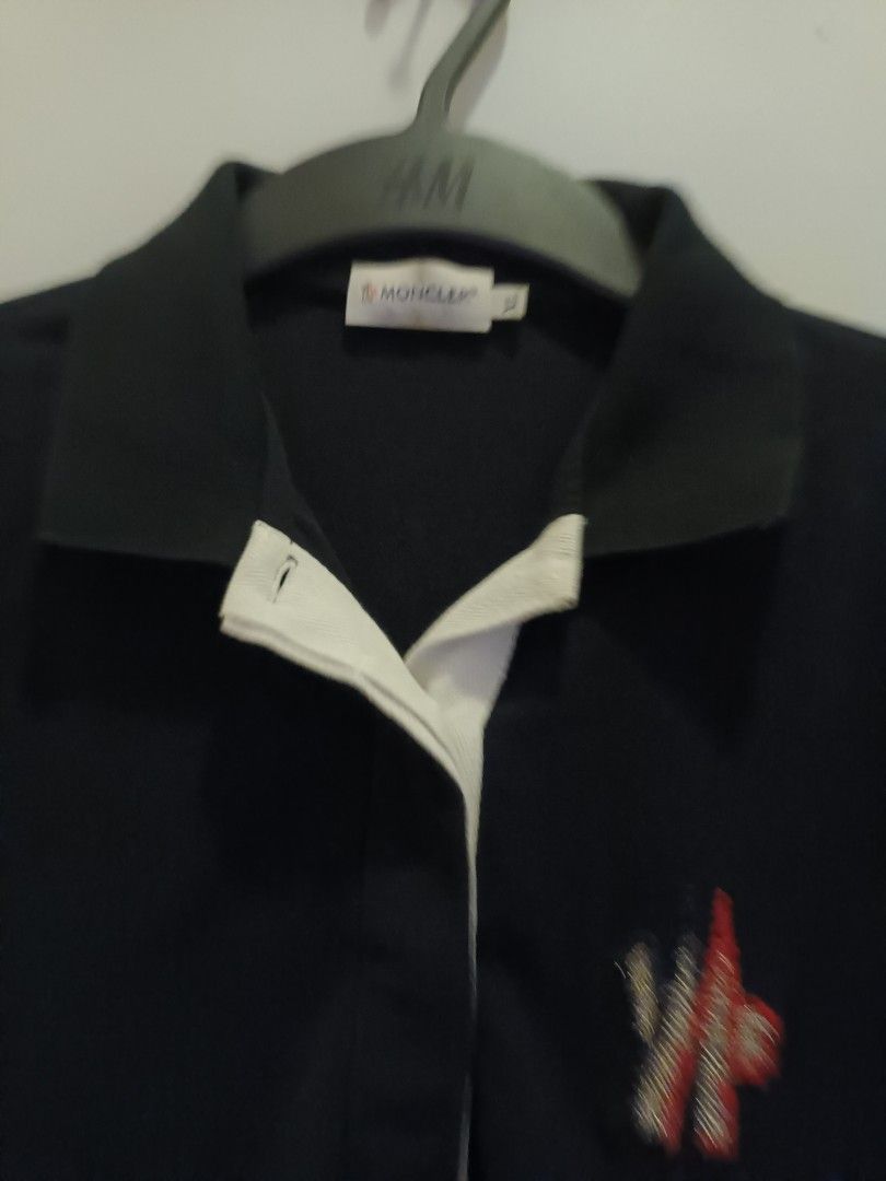 Moncler Polo Shirt - Black (Category: Activewear) located in Quezon City. Submitted by cncarousel (Listing ID 1423348158, Image 2). Description: - Moncler black polo shirt - Size: XL - White collar - Short sleeves - Small logo on chest - Buttoned placket - Solid, dark fabric.
