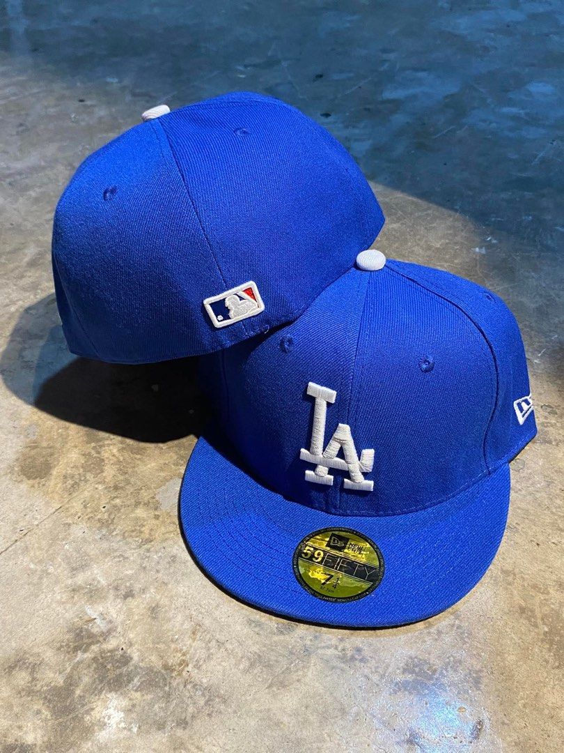 New Era 59FIFTY Los Angeles Dodgers Cap (Category: Caps & Hats) located in Dinalupihan. Submitted by capsnpffs (Listing ID 1423320360, Image 1). Description: - New Era 59FIFTY cap - Features the Los Angeles Dodgers logo - Color: Blue - Embroidered white 'LA' logo on front - Includes MLB logo on the side - New Era sticker on the brim - Size: 7 1/8.