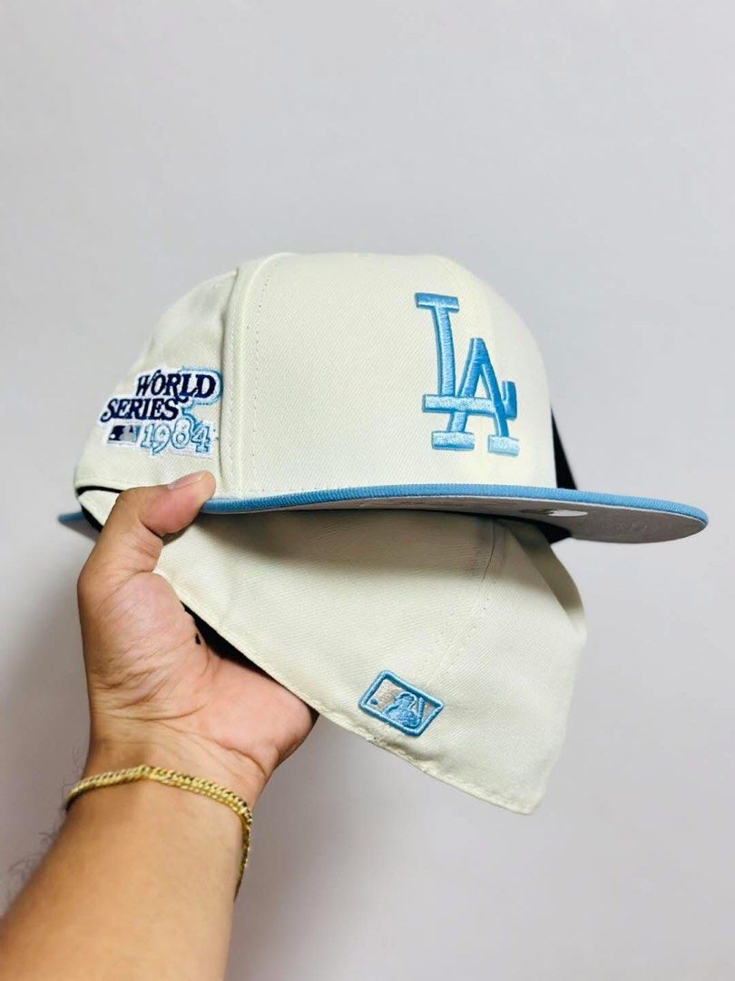 New Era LA Dodgers World Series Cap (Category: Caps & Hats) located in Dinalupihan. Submitted by capsnpffs (Listing ID 1423319375, Image 1). Description: - LA Dodgers cap - Light blue logo and brim - Cream-colored crown - World Series 1964 patch - New Era logo - Stylish accessory for Dodgers fans.