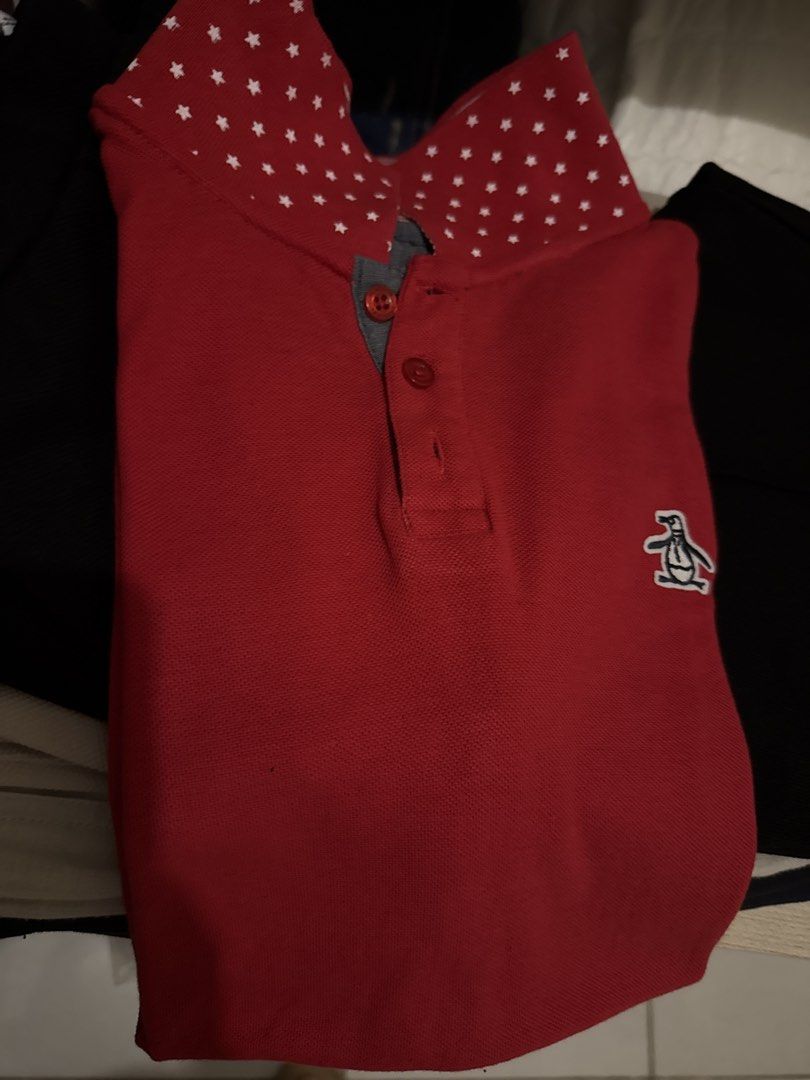 Original Penguin Red Polo Shirt (Category: Tshirts & Polo Shirts ) located in Talisay. Submitted by secondsbyvan (Listing ID 1423385463, Image 1). Description: Original Penguin polo shirt in red with a unique star-patterned collar. Features a classic three-button placket and the iconic Penguin logo on the chest. The collar lining has red and white stripes..