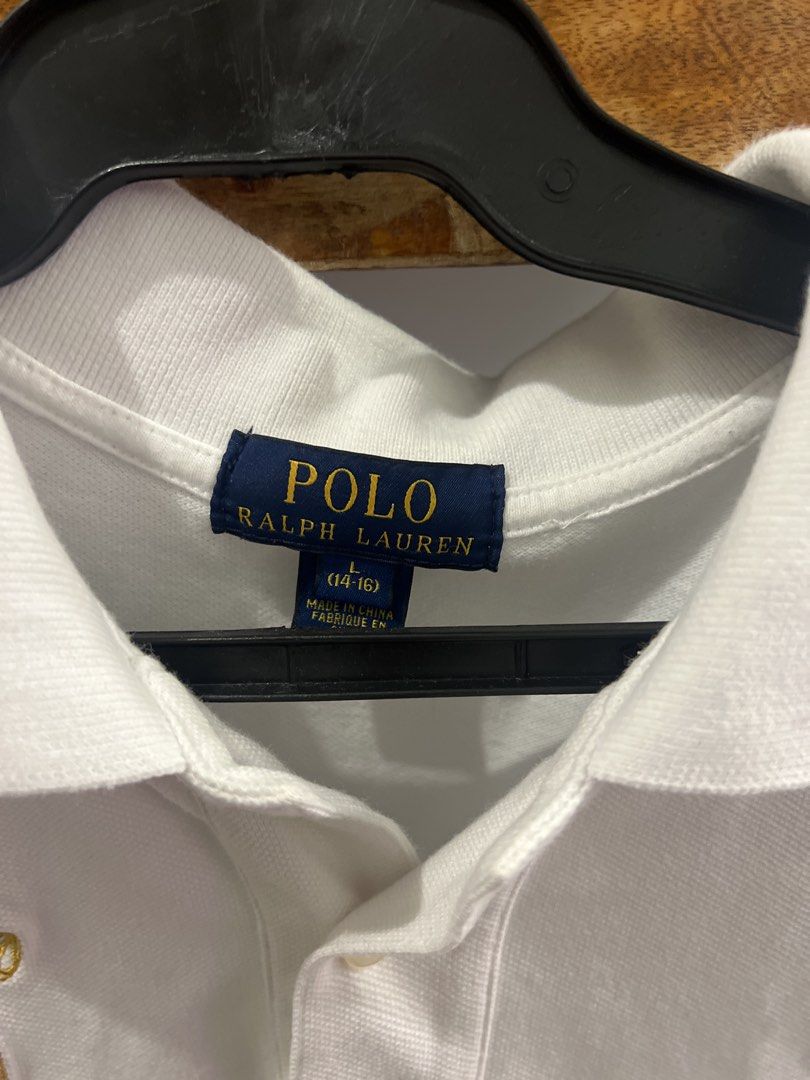 Polo Ralph Lauren White Polo Shirt (Category: Tshirts & Polo Shirts ) located in Baguio. Submitted by rhyac (Listing ID 1423290621, Image 2). Description: - Polo Ralph Lauren shirt - Size: L (14-16) - Features the iconic Polo logo - Includes a crest with the number '2' - Classic polo collar - Short sleeves - Made in Vietnam.