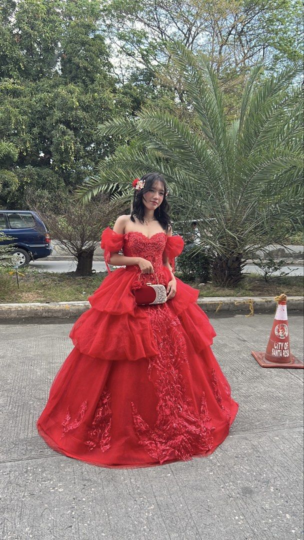 Red Shiny Ball Gown with Freebies (Category: Evening dresses & gowns) located in Santa Rosa. Submitted by sweetsillystuff (Listing ID 1423360487, Image 3). Description: - Elegant red ball gown - Off-shoulder design - Intricate embroidery - Layered skirt - Sweetheart neckline - Fitted bodice - Floor-length - Shimmering fabric - Perfect for special occasions, debut, js prom - with free gloves, headpiece, necklace, earclip and veil.