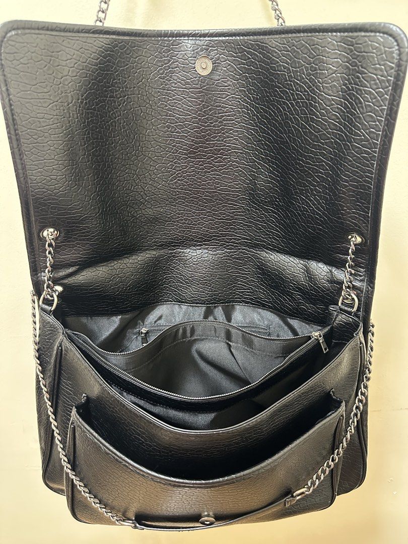 Saint Laurent Black Chain Bag big size (Category: Luxury Bags & Wallets) located in Los Banos. Submitted by ditasbautista2329 (Listing ID 1423432929, Image 3). Description: - Saint Laurent handbag - Black textured leather exterior - Features the iconic YSL logo - Silver chain strap - Flap closure - Multiple interior compartments - Includes Saint Laurent Paris label and tag.