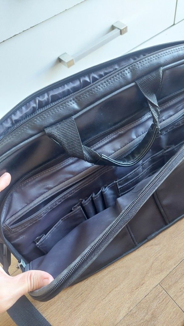 Samsonite Black Laptop Bag (Category: Laptop Bags & Sleeves) located in Quezon City. Submitted by sarisaribyronah (Listing ID 1423363704, Image 3). Description: - Black Samsonite laptop bag - Includes a shoulder strap and handle - Multiple compartments for organization - Features several zippered pockets - Durable material - Sleek design - Interior pockets for belongings Price negotiable.
