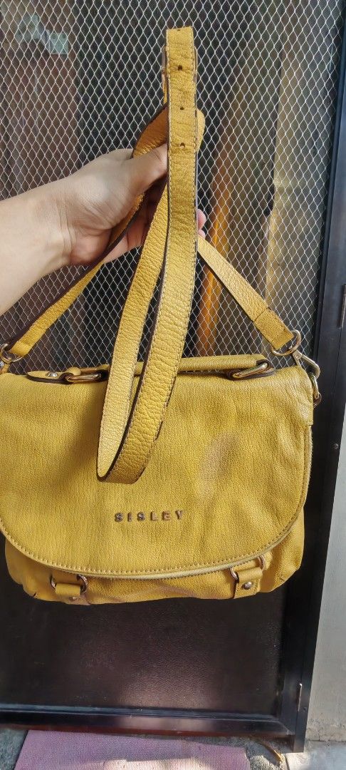 Sisley Yellow Sling Bag (Category: Shoulder Bags) located in Rizal. Submitted by annmaria_declutter (Listing ID 1423293387, Image 2). Description: - Sisley yellow shoulder bag - Flap closure with magnetic snap - Top handle and detachable shoulder strap - Exterior zippered pocket - Interior zippered pocket - Patterned interior lining - Gold-toned hardware -A very cute Sisley, i use it as kili. Small to medium size, ykk zip. Og po,. Flaw was shown 