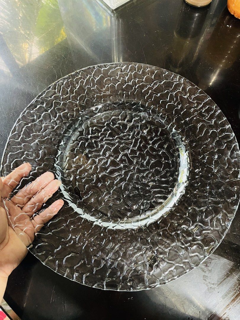 Textured Glass Charger Plate (Category: Dinnerware & Cutlery) located in Bugallon. Submitted by aennleeza (Listing ID 1423308172, Image 1). Description: Elegant glass charger plate with a unique textured surface. The plate has a wide rim and a clear, transparent appearance. Perfect for adding a touch of sophistication to your table setting. Ideal for special occasions or everyday use. 🇺🇸🇺🇸.