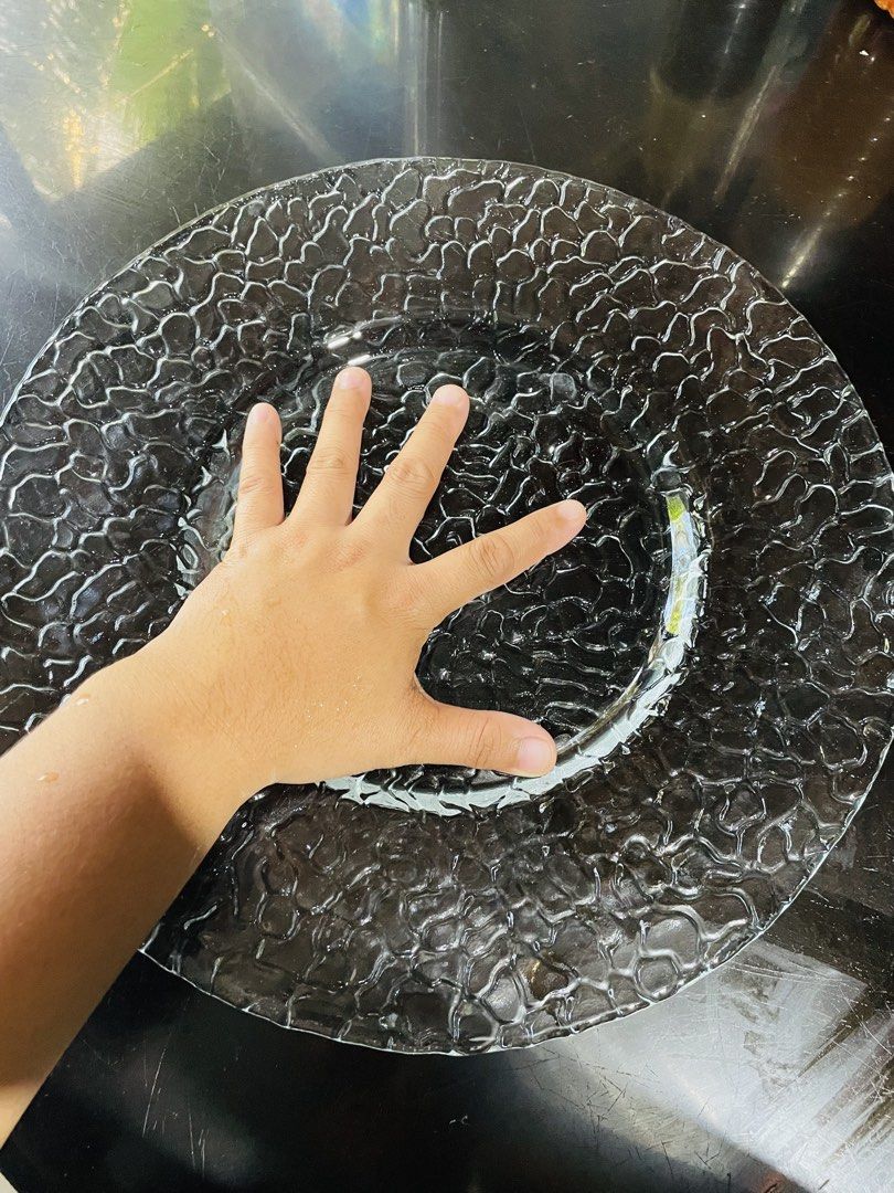 Textured Glass Charger Plate (Category: Dinnerware & Cutlery) located in Bugallon. Submitted by aennleeza (Listing ID 1423308172, Image 2). Description: Elegant glass charger plate with a unique textured surface. The plate has a wide rim and a clear, transparent appearance. Perfect for adding a touch of sophistication to your table setting. Ideal for special occasions or everyday use. 🇺🇸🇺🇸.