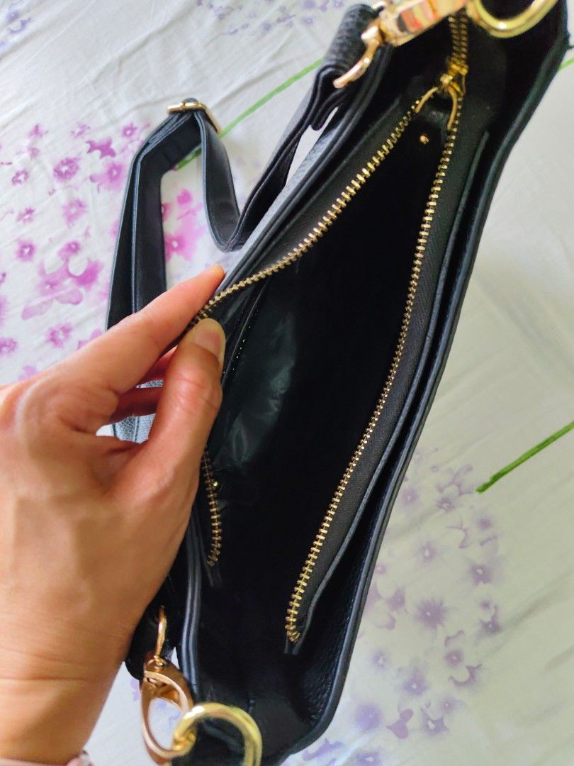 Tory Burch Black Shoulder Bag (Category: Luxury Bags & Wallets) located in Pasig City. Submitted by janelchoo (Listing ID 1423299875, Image 2). Description: - class A Tory Burch shoulder bag - Black with gold-tone hardware - Curved design - Top zipper closure - Interior zippered pocket - Shoulder strap - Tory Burch logo detail.