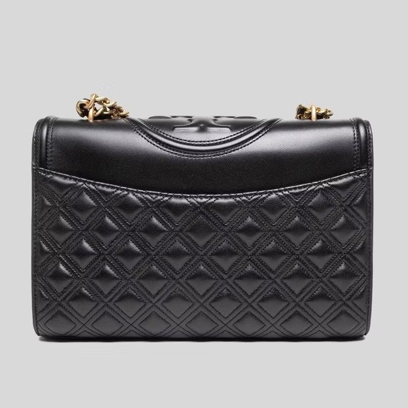 Tory Burch Fleming Bag (Category: Luxury Bags & Wallets) located in Silang. Submitted by declutter_cat (Listing ID 1423353468, Image 3). Description: - Black quilted leather shoulder bag - Gold chain strap - Tory Burch logo on flap closure - Features a tassel detail - Interior pocket - Convertible design: can be worn as shoulder bag or crossbody Authentic TB, Like New, sign pf usage. RFS: declutter No inclusions.