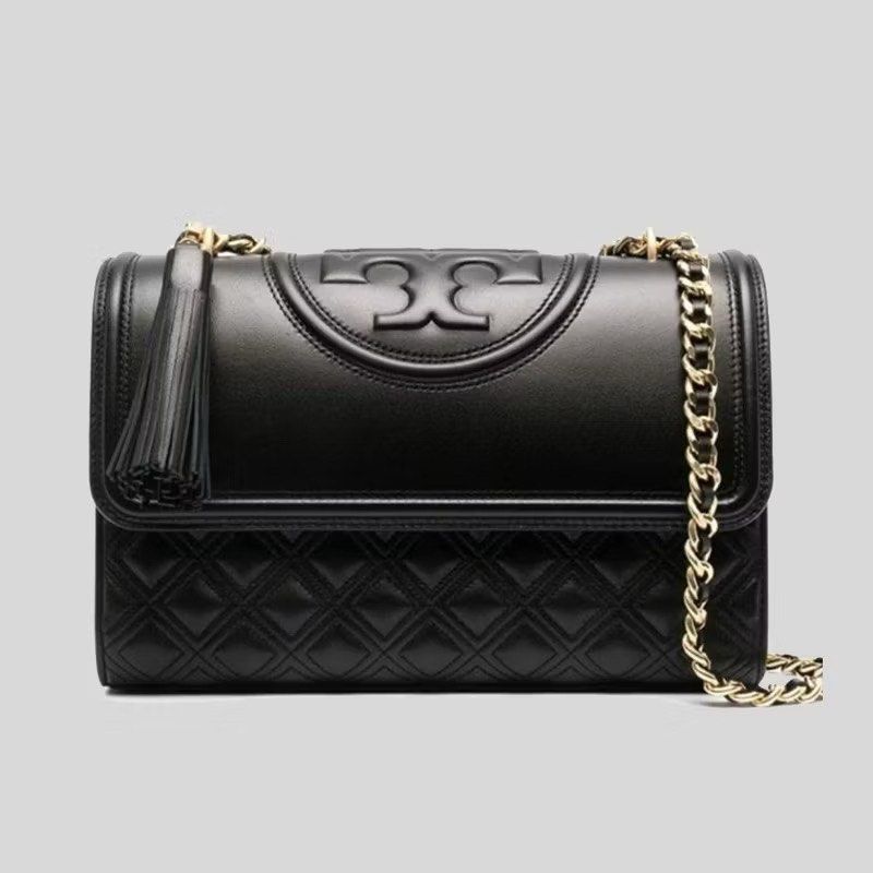 Tory Burch Fleming Bag (Category: Luxury Bags & Wallets) located in Silang. Submitted by declutter_cat (Listing ID 1423353468, Image 1). Description: - Black quilted leather shoulder bag - Gold chain strap - Tory Burch logo on flap closure - Features a tassel detail - Interior pocket - Convertible design: can be worn as shoulder bag or crossbody Authentic TB, Like New, sign pf usage. RFS: declutter No inclusions.