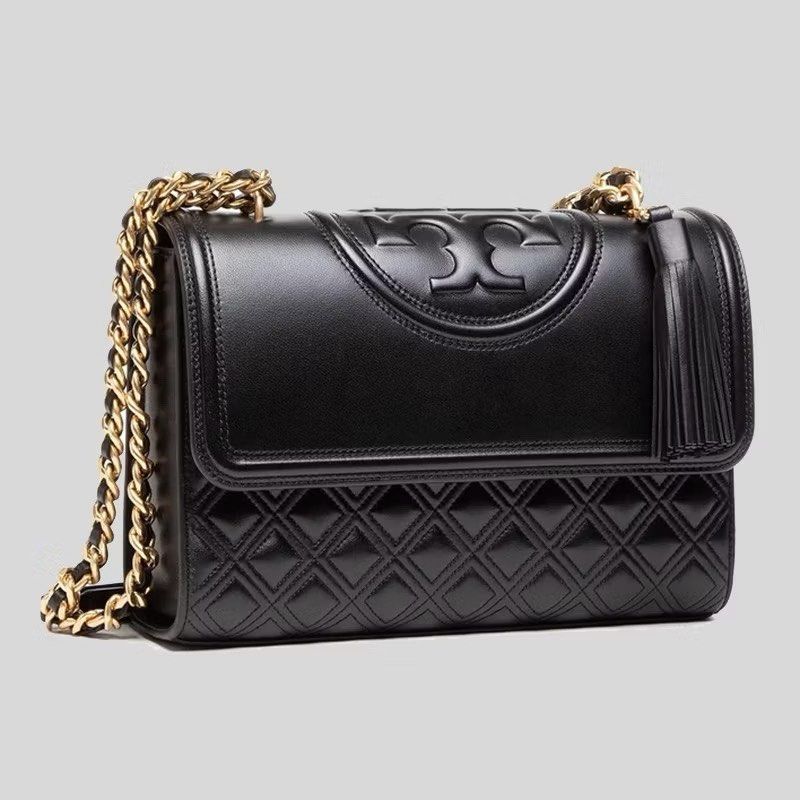 Tory Burch Fleming Bag (Category: Luxury Bags & Wallets) located in Silang. Submitted by declutter_cat (Listing ID 1423353468, Image 2). Description: - Black quilted leather shoulder bag - Gold chain strap - Tory Burch logo on flap closure - Features a tassel detail - Interior pocket - Convertible design: can be worn as shoulder bag or crossbody Authentic TB, Like New, sign pf usage. RFS: declutter No inclusions.