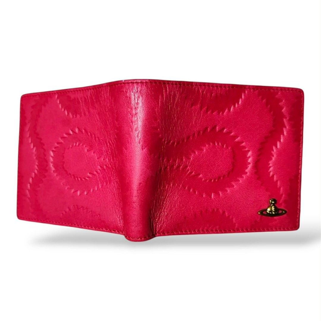 Vivienne Westwood Squiggle Bifold Wallet (authentic) (Category: Luxury Bags & Wallets) located in Cebu City. Submitted by westleygics18 (Listing ID 1423424165, Image 2). Description: Vivienne Westwood Squiggle Bifold Wallet (authentic) - Brand new Condition - Made in Italy - 100% Genuine Leather - Fuchsia / Raspberry Pink with Tan/Beige interior - 8 Card slots (4 on each side) - 2 Side slip pockets - Double bill compartment with red fabric lining