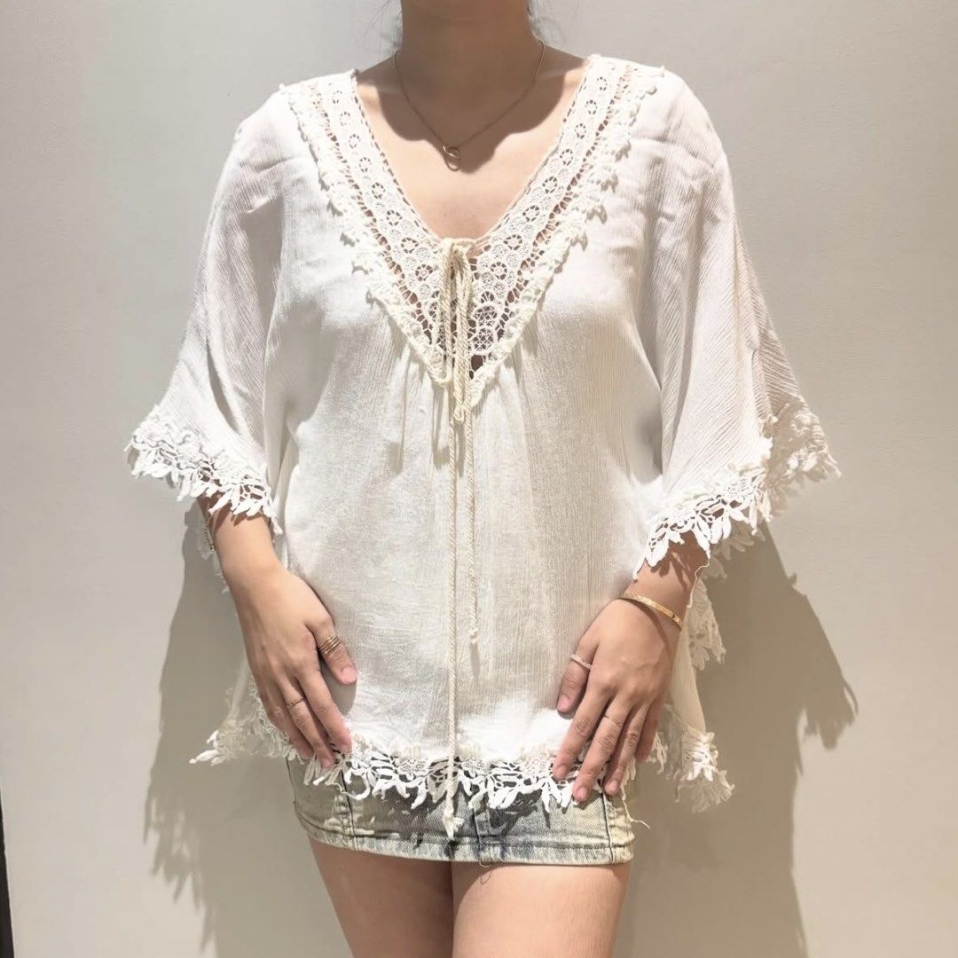 White Lace Trim Poncho Top (Category: Sleeveless) located in Davao. Submitted by byeooool (Listing ID 1423295111, Image 1). Description: - Free size, v high quality - Lace trim detailing - V-neckline with tie closure - Low back - Lace on sleeves and hem - Loose, flowing fit 10/10 condition, no flaws at all. Helping: Cottagecore Vintage Y2K Soft girl Grunge Brandy Melville Mango Zara Araw The Line Miu American Eagle Hollister.