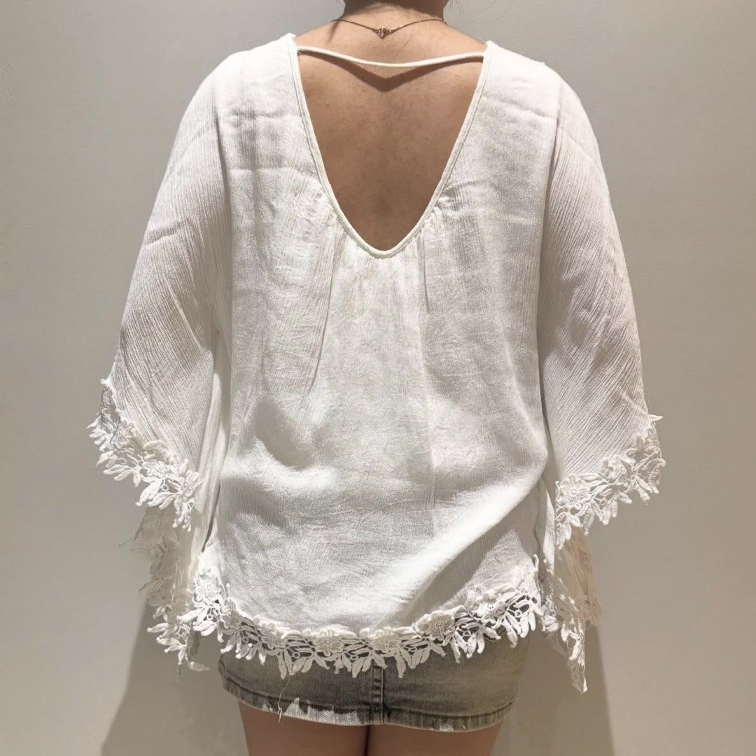 White Lace Trim Poncho Top (Category: Sleeveless) located in Davao. Submitted by byeooool (Listing ID 1423295111, Image 2). Description: - Free size, v high quality - Lace trim detailing - V-neckline with tie closure - Low back - Lace on sleeves and hem - Loose, flowing fit 10/10 condition, no flaws at all. Helping: Cottagecore Vintage Y2K Soft girl Grunge Brandy Melville Mango Zara Araw The Line Miu American Eagle Hollister.