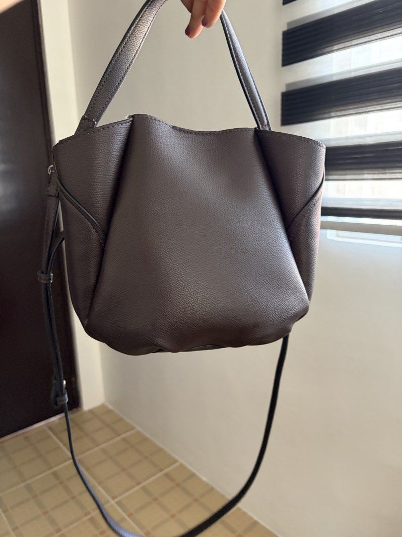 Zara Bucket Bag in Dark Brown (Category: Shoulder Bags) located in Las Pinas. Submitted by ynalcx (Listing ID 1423320278, Image 2). Description: - RFS: Impulse buy - ‼️: Has minimal cracking on top part of the bag, CHECK PHOTOS FIRST. - Bought in Japan - Can be worn as a handbag or as a crossbody - Handbag strap and crossbody strap are both detachable - Pouch inside is also detachable.