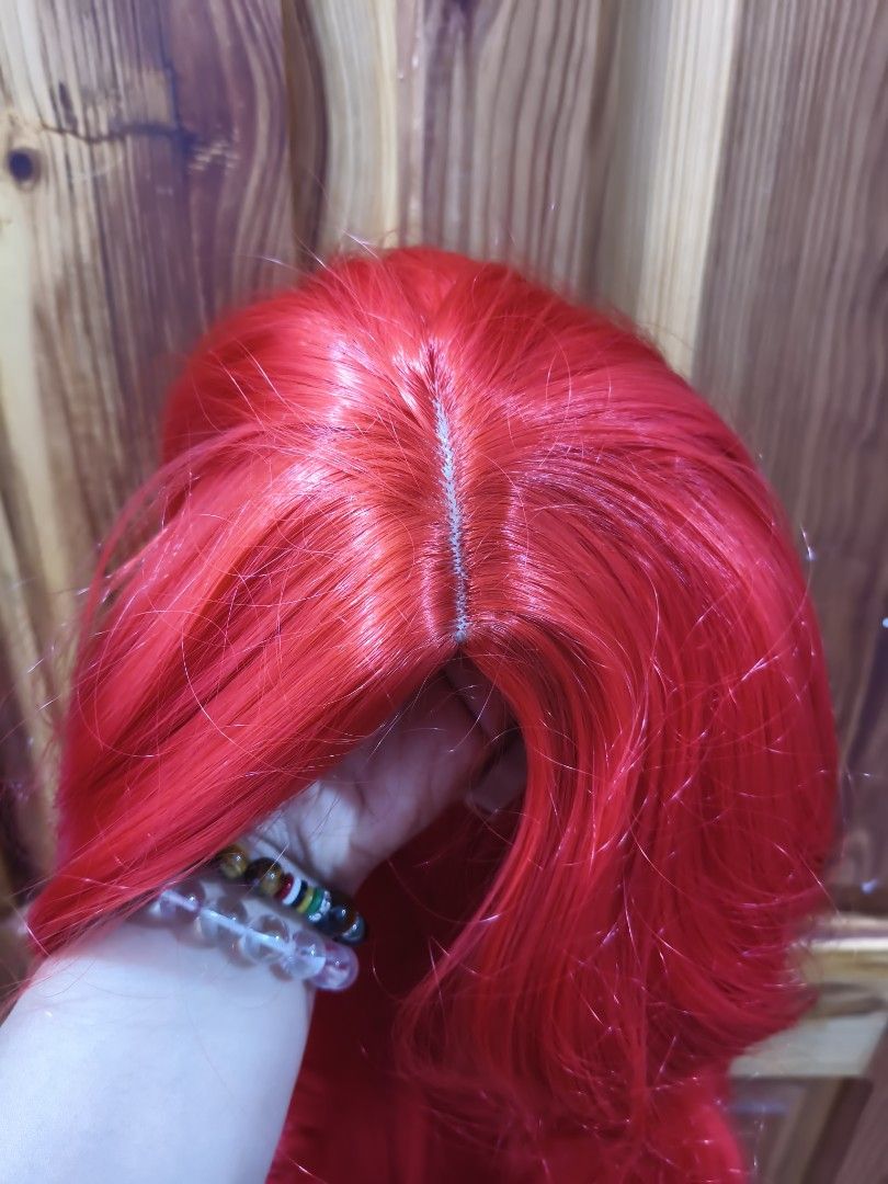 22 Inches Long Red Curly Wig (Category: Hair Accessories) located in Bontoc. Submitted by shaneebhee (Listing ID 1423485795, Image 2). Description: - Long, vibrant red curls - Center part - Mesh cap with adjustable straps - Made of synthetic fibers - Perfect for cosplay, costume parties, or a bold look.