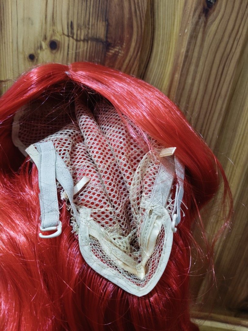 22 Inches Long Red Curly Wig (Category: Hair Accessories) located in Bontoc. Submitted by shaneebhee (Listing ID 1423485795, Image 3). Description: - Long, vibrant red curls - Center part - Mesh cap with adjustable straps - Made of synthetic fibers - Perfect for cosplay, costume parties, or a bold look.