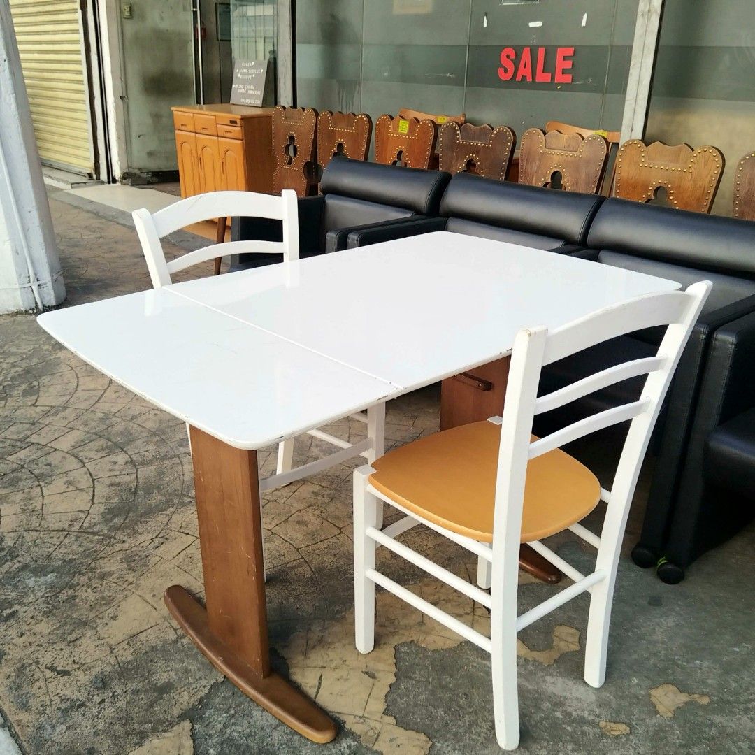 2nd hand Extendable Table with 2 Chairs | 3pcs set (Category: Tables & Sets) located in Paranaque City. Submitted by 2ndcharmfurniture (Listing ID 1423525110, Image 3). Description: Dining set includes an extendable table and two chairs. The table dimensions are L92-120cm, W75cm, and H71cm. The chairs are L40cm, D38cm, and H84cm, with a seat height of 44cm. The table is white, and the chairs have white frames with wooden seats. The set is perfect