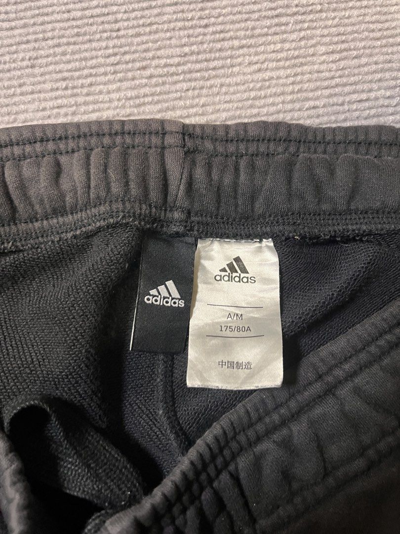 Adidas Black Sweatpants A/M 175/80A (Category: Joggers) located in Itogon. Submitted by taulom (Listing ID 1423543546, Image 3). Description: - Black Adidas sweatpants - Features Adidas logo on left leg and wordmark on right leg - Size: A/M 175/80A - Elastic waistband - Pockets included.