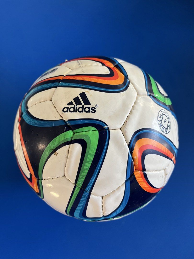 Adidas Brazuca Soccer Ball (Category: Racket and Ball Sports) located in Calasiao. Submitted by xwbj4ycjw975281 (Listing ID 1423475676, Image 1). Description: - Adidas Brazuca soccer ball - White base with blue, green, orange, and black curved panels - Features the Adidas logo - Perfect for recreational play.