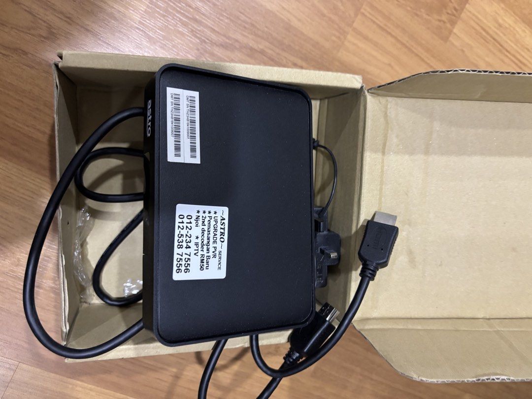 Astro Decoder (Category: TV Parts & Accessories) located in Semenyih. Submitted by oddwater.ac8a92 (Listing ID 1423581657, Image 3). Description: Astro decoder with cables. The box has a model number DM7853. The country of origin is Thailand. Includes an HDMI cable. The box has the Astro Go Beyond logo. The decoder has a sticker with a serial number and Astro service information..