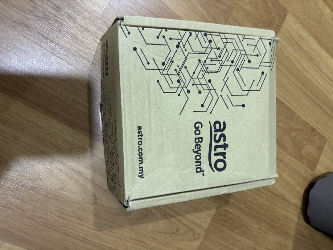 Astro Decoder (Category: TV Parts & Accessories) located in Semenyih. Submitted by oddwater.ac8a92 (Listing ID 1423581657, Image 2). Description: Astro decoder with cables. The box has a model number DM7853. The country of origin is Thailand. Includes an HDMI cable. The box has the Astro Go Beyond logo. The decoder has a sticker with a serial number and Astro service information..