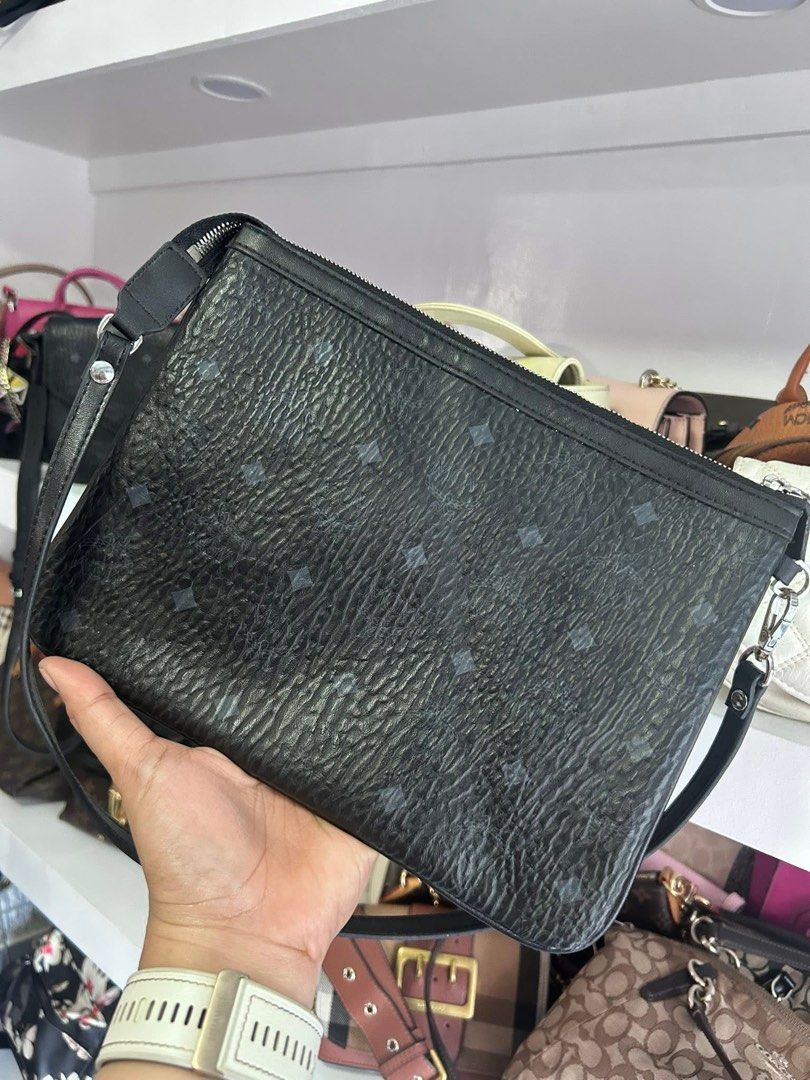 Authentic MCM Black Big Pouch Clutch Wristlet (Category: Luxury Bags & Wallets) located in Quezon City. Submitted by lexi.cloud (Listing ID 1423496362, Image 1). Description: ⚜️ guaranteed authentic ⚜️ 10/10 condition ⚜️ no flaws, no signs of usage ⚜️ preloved ⚜️ no inclusions money back guaranteed if proven fake. pm for sure buyers only..