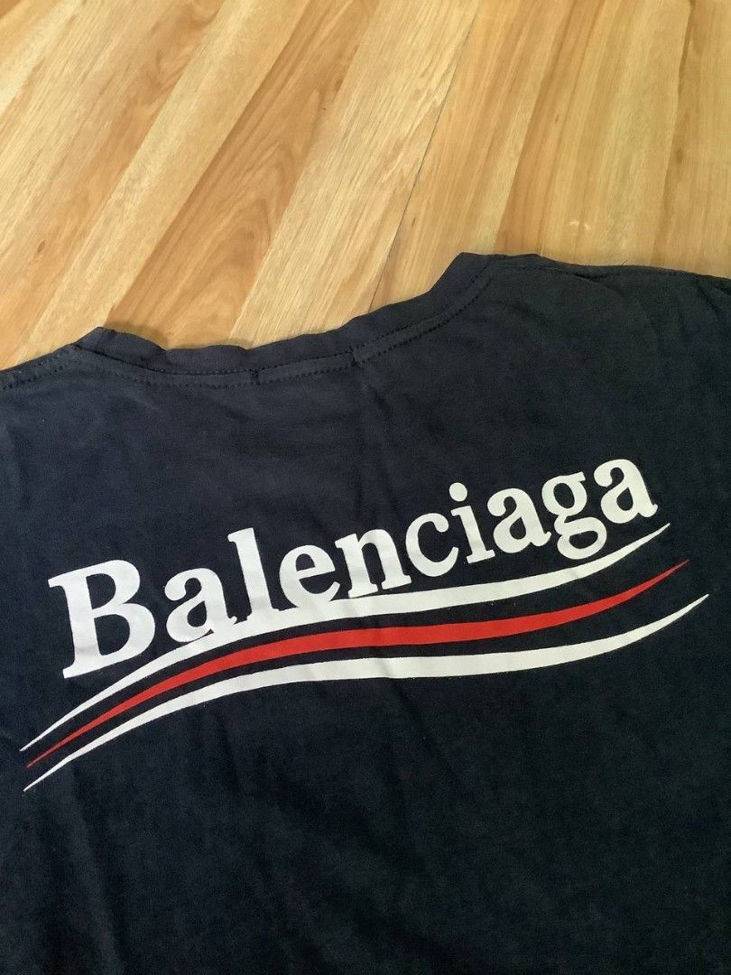 Balenciaga Logo T-shirt (Category: Luxury Apparel) located in Nabua. Submitted by stayhypethrifted (Listing ID 1423505769, Image 3). Description: - Authentic Balenciaga T-shirt - Features the Balenciaga logo on the front and back - Classic crew neck design - Short sleeves - Made in Portugal - Includes a stylish red and white stripe design.
