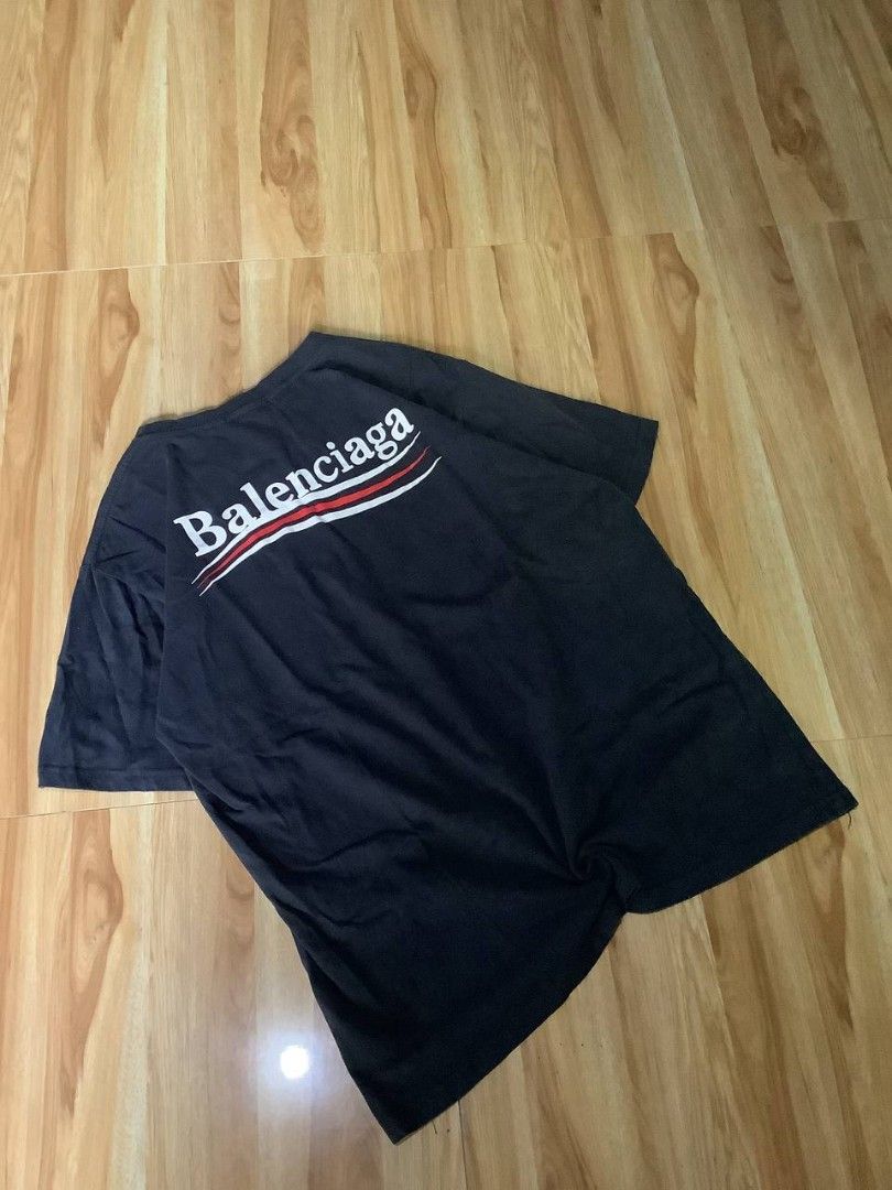 Balenciaga Logo T-shirt (Category: Luxury Apparel) located in Nabua. Submitted by stayhypethrifted (Listing ID 1423505769, Image 1). Description: - Authentic Balenciaga T-shirt - Features the Balenciaga logo on the front and back - Classic crew neck design - Short sleeves - Made in Portugal - Includes a stylish red and white stripe design.