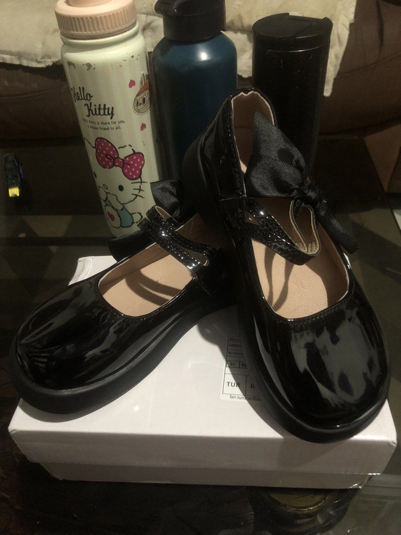 Black Mary Jane Shoes with Bow (Category: Babies & Kids Fashion) located in Morong. Submitted by brendani (Listing ID 1423502578, Image 1). Description: - Brand new black Mary Jane shoes - Features a charming bow detail - Glossy, eye-catching finish - Classic strap across the top - Durable, textured black sole - Comes in original box with manufacturer's information.