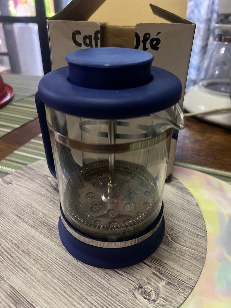 Cafe Ole French Press Coffee & Tea Maker (Category: Coffee Machines & Makers) located in San Pedro. Submitted by mighty_oh (Listing ID 1423541542, Image 1). Description: Brew your own coffee or tea with this Cafe Ole French Press. It features a blue lid and handle, with a glass beaker and stainless steel plunger. The box includes instructions for use. Made in Taiwan. Perfect for making coffee or tea at home..