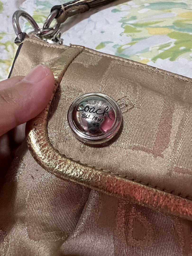 Coach Handbag and Wallet Set (Category: Luxury Bags & Wallets) located in Manila. Submitted by tjsells.101 (Listing ID 1423470042, Image 2). Description: - Authentic Coach set (handbag and wallet). - Gold-toned exterior with signature Coach pattern. - Handbag: - Top handle - Front flap pocket - Purple fabric lining - Wallet: - Multiple card slots - Snap closure - Both items feature the Coach logo..