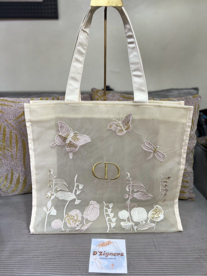 Dior Embroidered Tote Bag gift with purchase (Category: Luxury Bags & Wallets) located in Quezon City. Submitted by DZignersbyZsa (Listing ID 1423574714, Image 1). Description: - Authentic Dior tote bag gift with purchase - Delicate floral and butterfly embroidery - Sheer, cream-colored exterior - Luxurious satin handles - Gold-colored CD logo - Spacious design - Perfect for carrying essentials Brandnew sealed inside the plastic original packagin